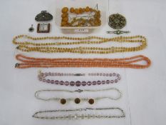 String of graduated amber-coloured beads, coral beads, crystal and similar vintage bead necklaces