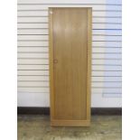 Meredew single wardrobe with panelled door enclosing shelf and hanging space, on plinth base,