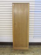 Meredew single wardrobe with panelled door enclosing shelf and hanging space, on plinth base,