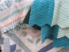 Modern quilt, a wool counterpane and a knitted blanket (1 box)