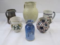 Quantity of studio pottery to include blue and red polka dot jug marked 'Goldsmiths' to base, studio