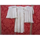 Two cotton and lace babygowns, a cotton sleeveless petticoat and a fine wool shawl marked 'Rob Roy'