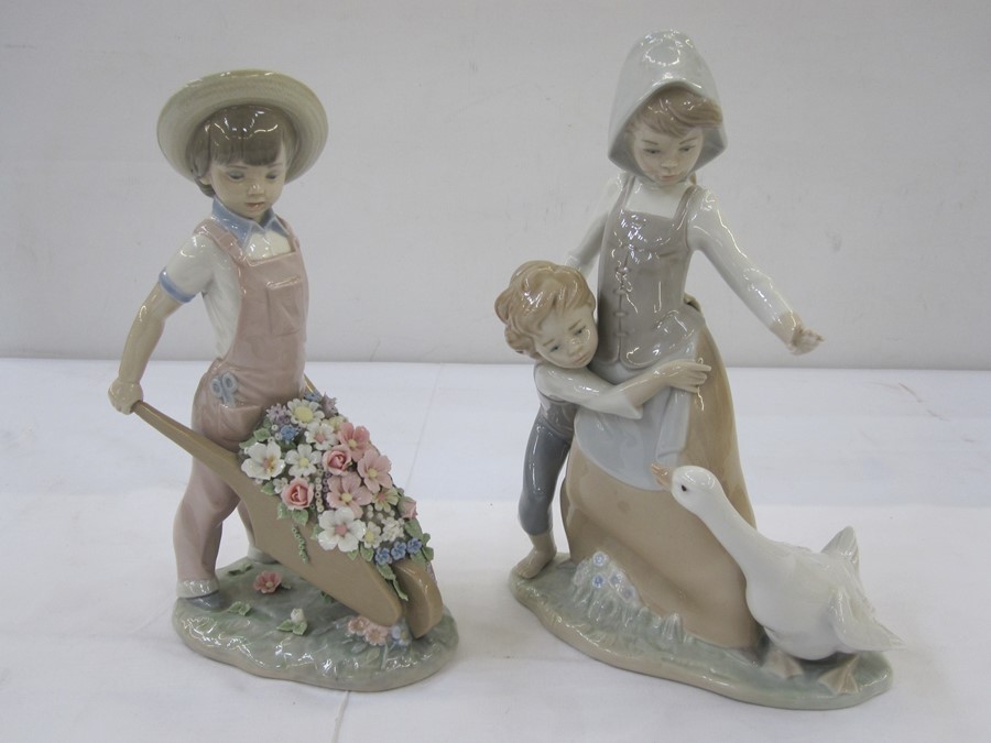 Lladro figure of young boy in pink dungarees with floral encrusted wheelbarrow and Lladro figure