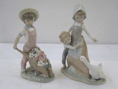 Lladro figure of young boy in pink dungarees with floral encrusted wheelbarrow and Lladro figure