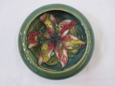Moorcroft circular dish, green ground, floral decorated, 13cm diameter