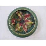 Moorcroft circular dish, green ground, floral decorated, 13cm diameter