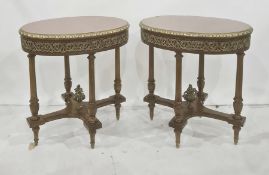 Pair of walnut occasional tables of oval form, the tops with parquetry star design, with gilt