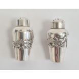 Chinese silver miniature pepper pots shouldered and tapering, each embossed with dragon and pearl