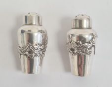 Chinese silver miniature pepper pots shouldered and tapering, each embossed with dragon and pearl