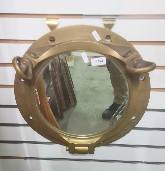Wall mirror set in brass porthole frame, 37cm wide