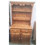 Modern pine dresser, the plate rack fitted with four small drawers, the base with two drawers and