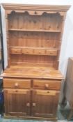 Modern pine dresser, the plate rack fitted with four small drawers, the base with two drawers and