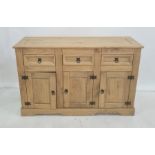 20th century pine sideboard, the rectangular top above three drawers, three cupboard doors, plinth