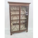Mahogany display case with dentil cornice, the two glazed doors enclosing five shelves on bracket