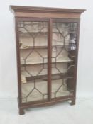 Mahogany display case with dentil cornice, the two glazed doors enclosing five shelves on bracket