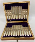 An early 20th century set of silver and mother of pearl handled dessert knives and forks, 12 person,