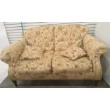Modern three piece suite comprising a two seater sofa and two armchairs in brown floral upholstery