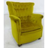 Early 20th century armchair with buttonback, upholstered in green velvet, on bun feet