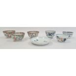 Three Chinese porcelain tea bowls with blue landscape and plant decoration, similar saucer and a set