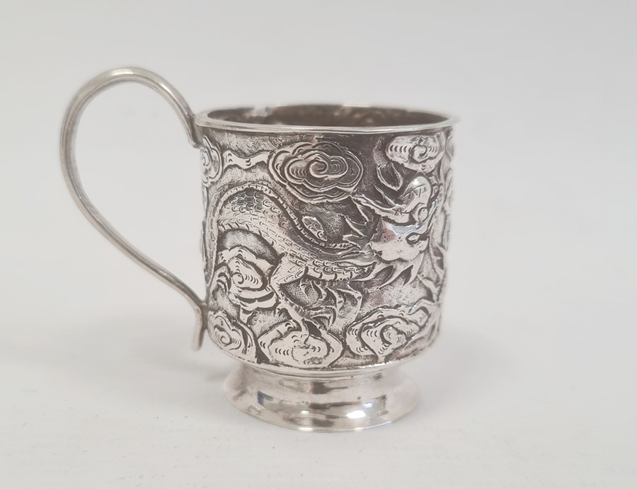 Chinese Hung Chong footed miniature cup, the cylindrical body repousse with dragons, having loop