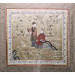 Chinese embroidered silk panel of square form depicting two ladies in a garden, within a border of