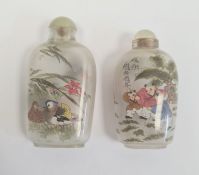 Two Chinese internally painted glass snuff bottles and stoppers, 8cm and 7cm high