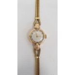 18ct gold lady's wristwatch with Arabic numerals to the dial on 18ct gold twin herringbone bracelet,