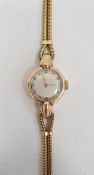 18ct gold lady's wristwatch with Arabic numerals to the dial on 18ct gold twin herringbone bracelet,