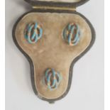 Set of three gold-coloured metal and turquoise enamel studs, knot-pattern, in trefoil-shaped morocco