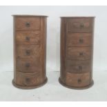 Pair of modern Eastern hardwood drum-shaped five-drawer chests, of circular form, five drawers