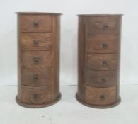 Pair of modern Eastern hardwood drum-shaped five-drawer chests, of circular form, five drawers