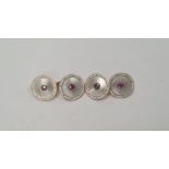 Pair of 15ct gold and ruby set cufflinks, the circular mother-of-pearl linked discs set within white