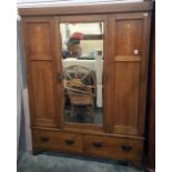 Early 20th century oak wardrobe with central mirror door flanked by decorative art nouveau inlaid