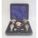 An early 20th century silver cruet set, Art Nouveau decoration and form, Birmingham 1908, maker