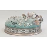 Large silver pin cushion by William Comyns, London 1908, of oval form, the frame with pierced