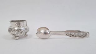Chinese silver sugar tongs with spoon ends and dragon embossed handles and a dragon embossed
