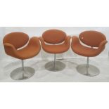 Three Artifort tulip chairs by Pierre Paulin upholstered in orange fabric on revolving aluminium