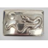 Chinese silver cigarette case, rectangular and curved, the hinged lid repousse with dragon chasing