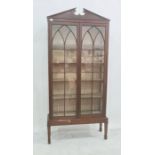 Mahogany glazed display case with broken arch pediment, the two glazed doors enclosing five
