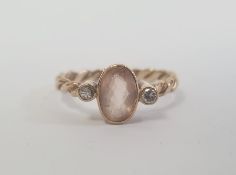 9ct gold, pale orange stone and diamond three-stone ring, the central oval pale orange stone 8mm x