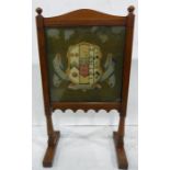 Oak firescreen with arched top, set with a woolwork tapestry depicting the Arms of Brasenose