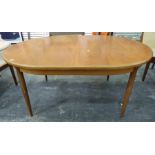 1970's G-Plan style teak extending dining table of oval form on tapering circular supports, 112 x