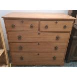 Early 20th century pine chest of two short and three long drawers, on plinth base and with Gothic