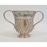 A Victorian silver two-handled trophy cup, central blank cartouche, semi-gadrooned, on circular