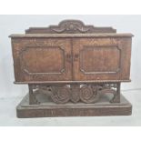 20th century oak sideboard, the rectangular top with rounded front corners, moulded and carved edge,