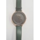 Lady's Skagen wristwatch with gilt metal and plain black matt face, on green leather strap