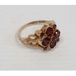 9ct gold lady's ring with four large and five small garnets, in flowerhead setting, 4.5g