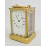 Brass carriage clock with Roman numerals to the dial