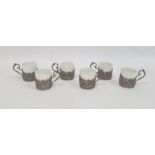 Set of six German silver coffee can holders, each decorated with a panel of cherubs within scrolling