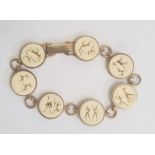 South African 9ct gold and ivory bracelet, seven circular ivory mounts depicting hunting scenes,